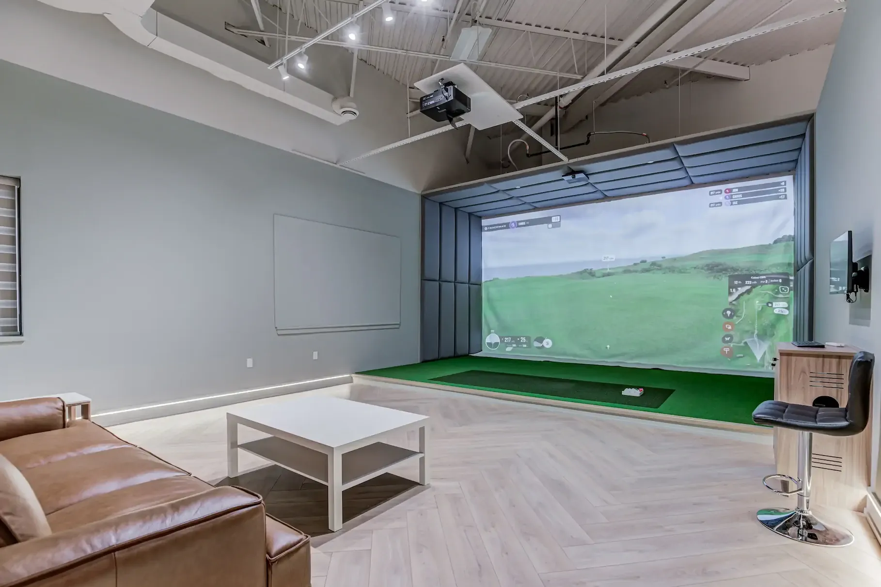 A private bay's Trackman simulator screen showing a course and shot data