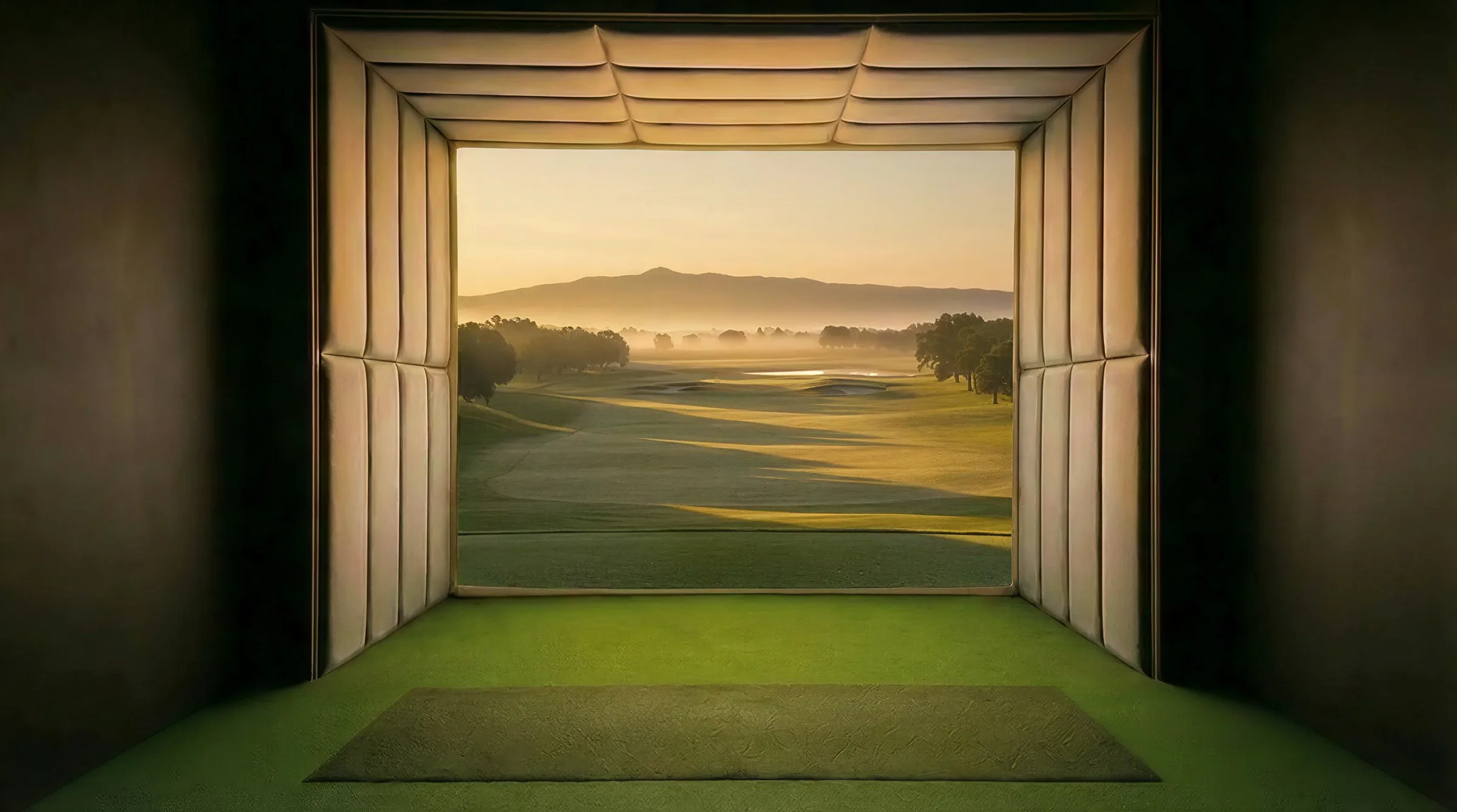 An AK Golf Studio simulator bay, its screen showing a fairway at sunrise